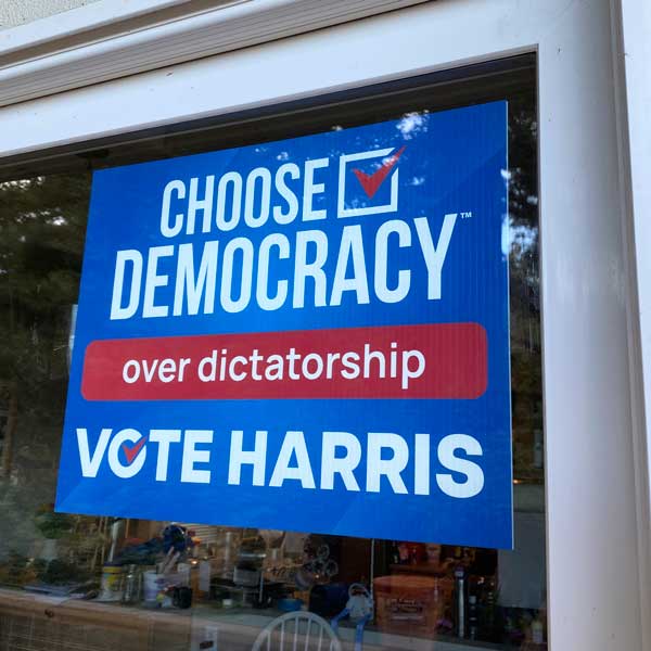 Vote Harris - Choose Democracy over dictatorship sign in window